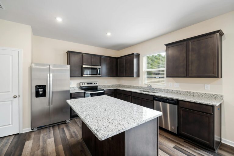 Luxurious modern kitchen featuring granite countertops and stainless steel appliances.